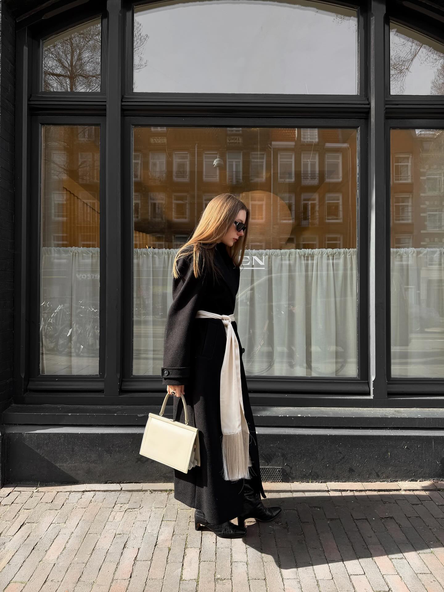 A Black Wrap Dress with a Cream Scarf for Refined City Dressing